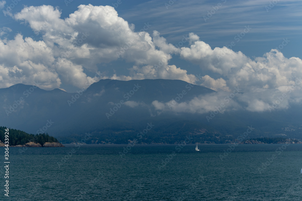 Coastal mountains almost hidden behind the clouds on the Pacific Ocean, BC, Canada