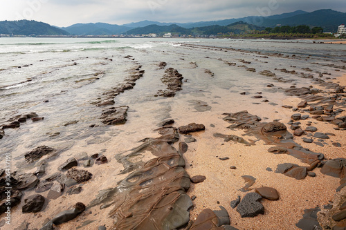 The famous Devils Washboard ('Oni no Sentakuita' in Japanese) surrounding Aoshima island, Miyazaki city, Kyushu, Japan. These are naturally formed geological exposed basalt rock formations.  photo