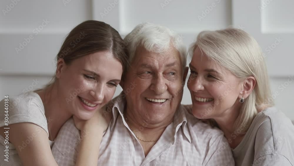 Happy family senior old parents and young adult daughter embracing Happy family senior old parents and young adult daughter embracing