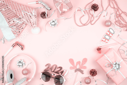 Pink pastel Christmas decoration for New Year's Eve frame. Modern new year 2020 party banner mockup on pink background with copy space