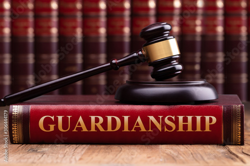 Gavel And Striking Block Over Guardianship Law Book Fototapeta