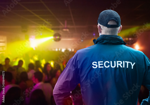 фотографія Male Security Officer Standing In Night Club