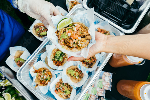 person grabbing a taco