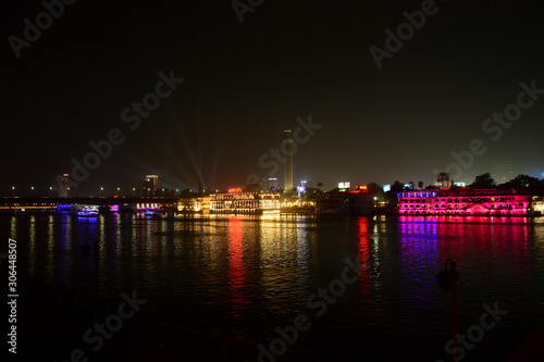 Beautiful view of river nile during night in Cairo Egypt showing light reflection from surrounding buildings and bouts © albertmansour