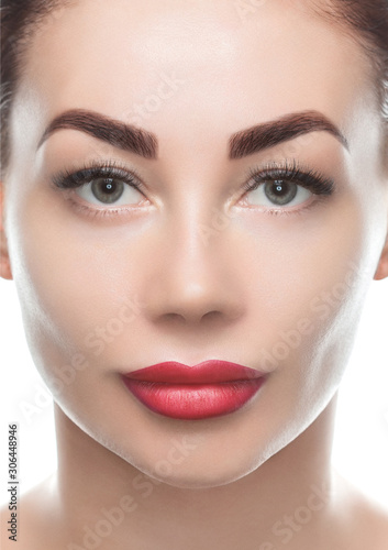 Portrait of a beautiful woman with clean skin and fresh make-up on a white background. Cosmetology and skin care. Face close-up. Make-up concept