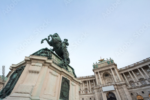 Hofburg palace, on its Neue Burg aisle, taken from the Heldenplatz square, with the 19th century Prinz Eugen statue in front in Vienna, Austria. It is the former Austro Hungarian imperial palace