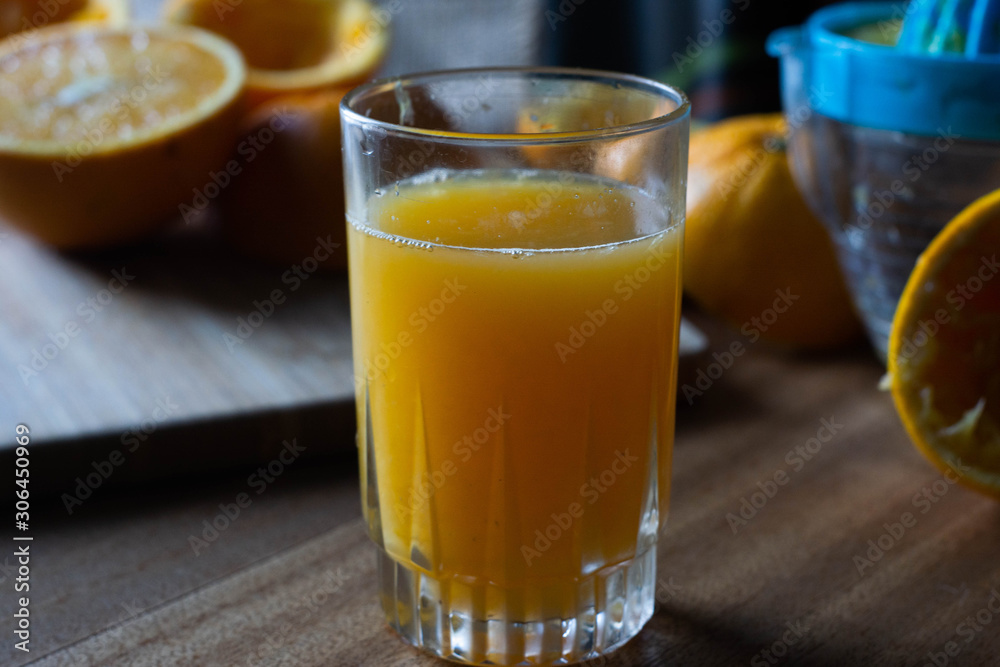 Orange juice on a table and juicer Orange juice on a table and juicer
