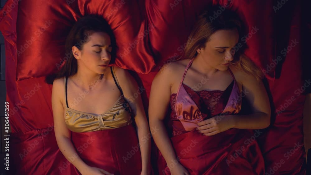 Two women sleeping in bed nervous girl waking up after nightmare, stressful life Two women sleeping in bed nervous girl waking up after nightmare, stressful life