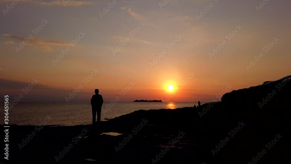 Timel apse of sunset, waving ocean and silhouettes of walking people on beach, part two Timel apse of sunset, waving ocean and silhouettes of walking people on beach, part two