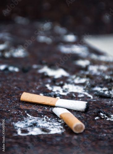 Cigarette and dirt on the floor