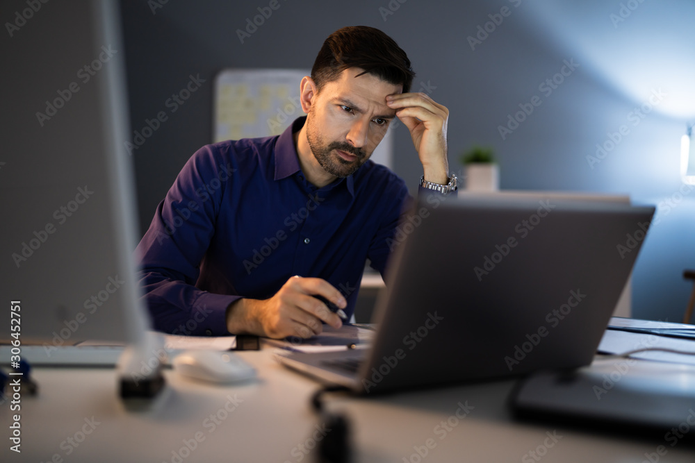 Stressed Accountant Working Late In Office Stressed Accountant Working Late In Office
