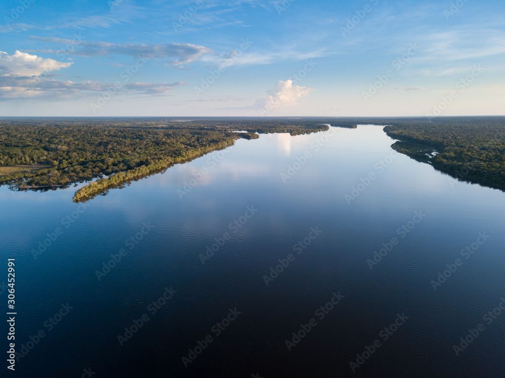 Beautiful aerial drone view of Xingu river in the Amazon rainforest on sunny summer day with blue sky. Mato Grosso, Brazil. Concept of nature, ecology, natural resources and environment.