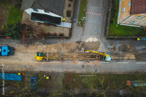 aerial view of construction site with excavators and other working machines. Works going on a city road © Anze