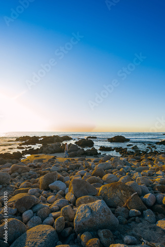 sunset on rocky coast of the sea