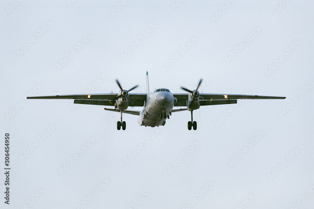 Fototapeta premium Freight military plane in the clear sky at evening time.
