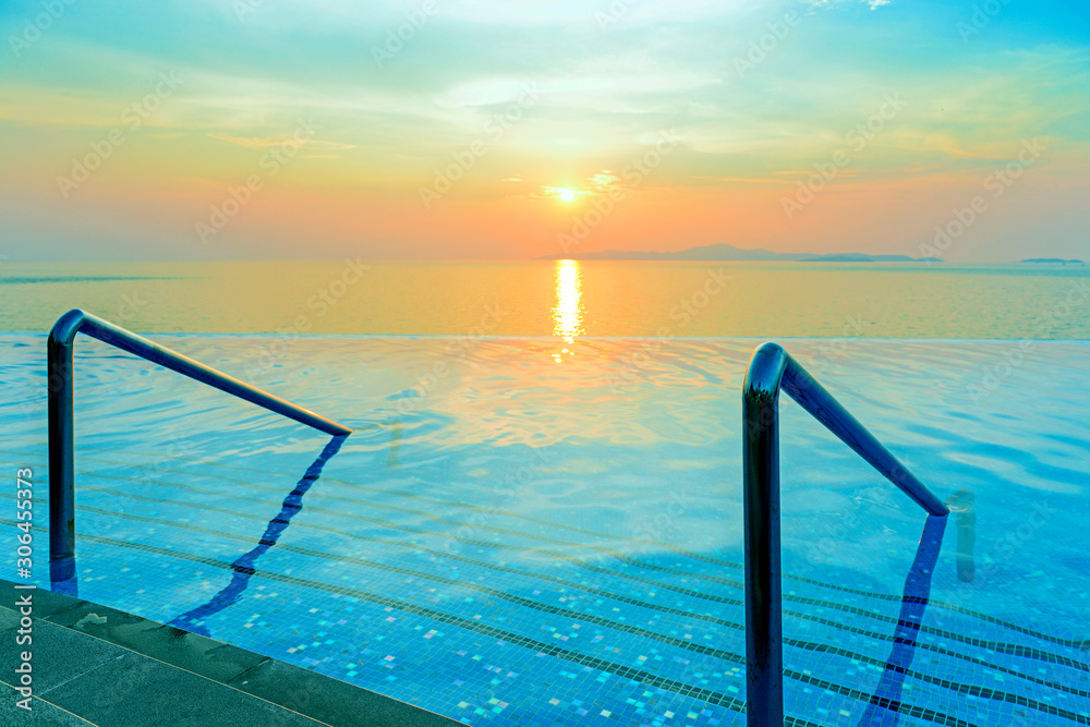 Fototapeta Swimming pool with stair and sunset background