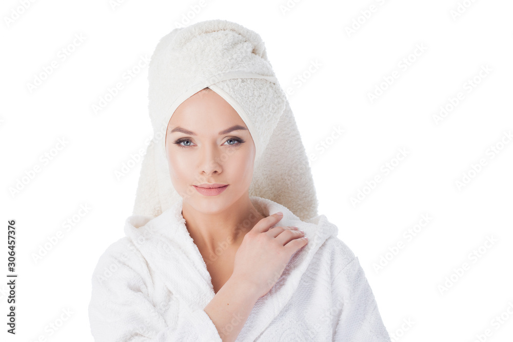 Beauty treatments after the bath. Portrait of a young beautiful woman in a Terry robe and with a towel on her head. Beauty treatments after the bath. Portrait of a young beautiful woman in a Terry robe and with a towel on her head.