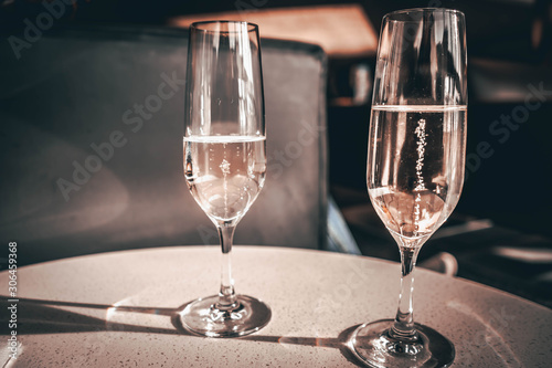 two glasses of white wine on table