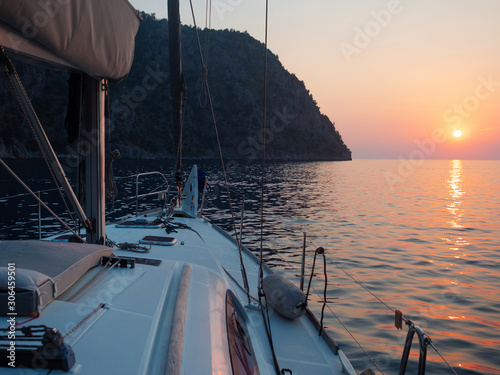 Meet the sunset in the Bay on Board the yacht, a romantic evening at sea. Boat trip on a yacht under sail.