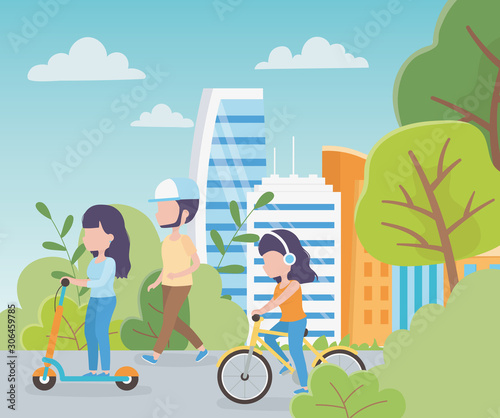 urban ecology young women riding kick scooters and man walking path park city