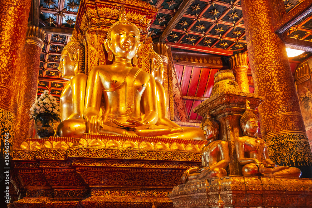 Four large stucco Buddha statues Turned the parson (back) colliding with his face towards the four directions At Phumin temple, Nan, Thailand