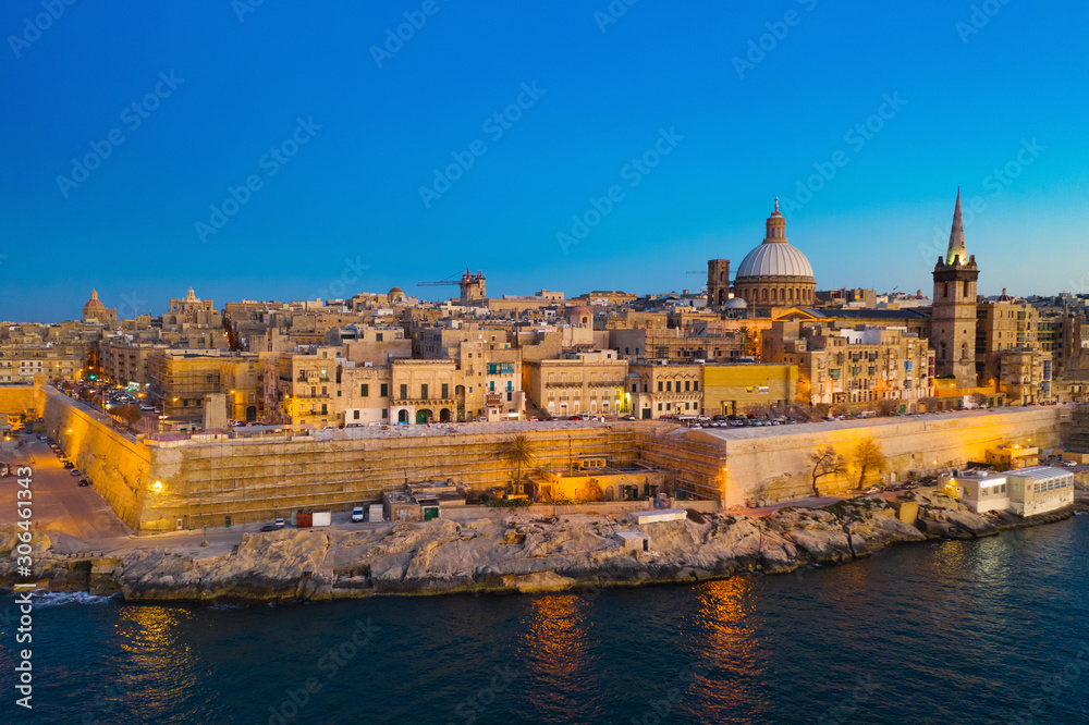 Valletta - capital of Malta. Aerial view, sunset, evening, church, blue sky and sea