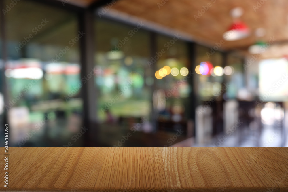 Empty dark wooden table in front of abstract blurred bokeh background of restaurant . can be used for display or montage your products.Mock up for space. Empty dark wooden table in front of abstract blurred bokeh background of restaurant . can be used for display or montage your products.Mock up for space.