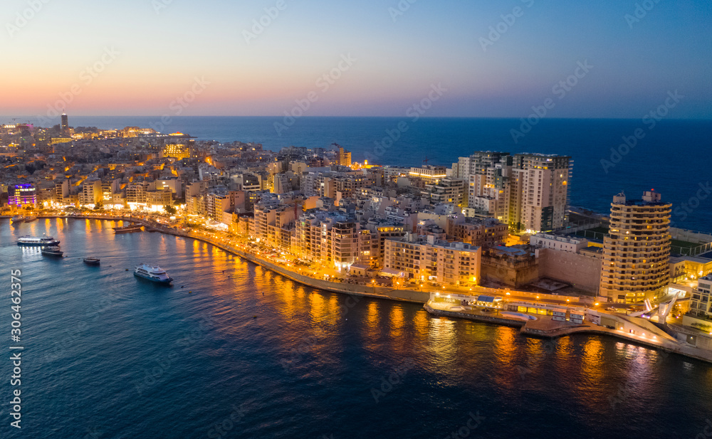 Sliema city on the evening, dusk. Aerial view. The Tigne Point complex and sea. Malta Sliema city on the evening, dusk. Aerial view. The Tigne Point complex and sea. Malta
