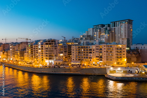 Waterfront Sliema city on the evening  dusk. Aerial view. The Tigne Point complex and sea. Malta island
