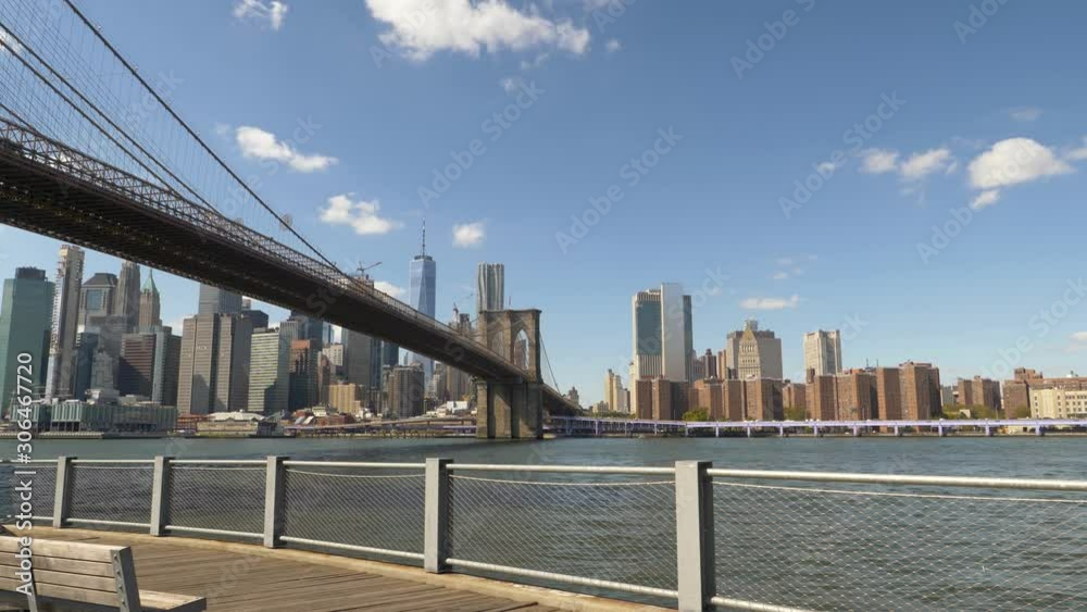 Lower Manhattan and East River Seen from Brooklyn Bridge Park Fence on Summer Afternoon Lower Manhattan and East River Seen from Brooklyn Bridge Park Fence on Summer Afternoon