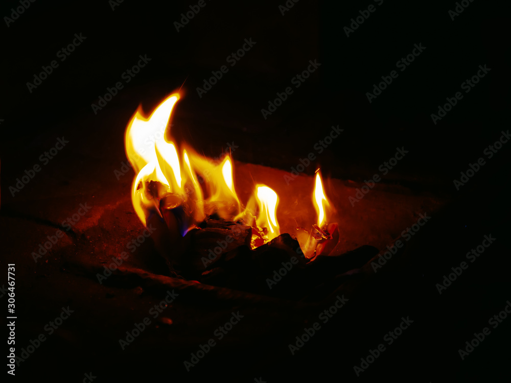 Flames of burning paper on a dark background close-up Flames of burning paper on a dark background close-up