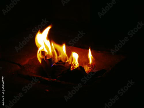 Flames of burning paper on a dark background close-up