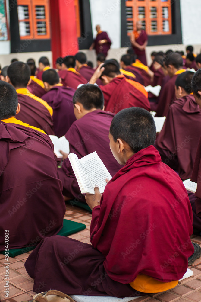 Buddhist Monks reading scripture in a monastery.