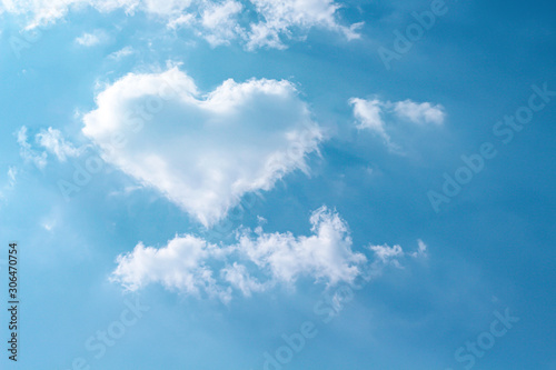 Fototapeta Naklejka Na Ścianę i Meble -  Clouds heart shaped patterns on bright blue sky with mild wind and reflection light from the sun for summer Valentine or wedding day love background