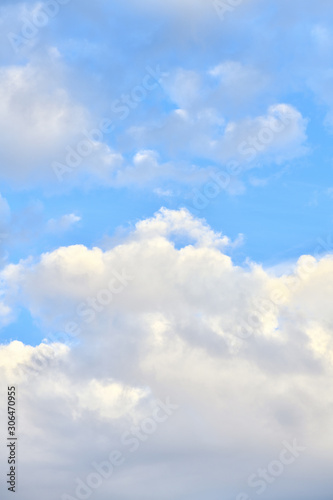 Beautiful blue sky with clouds on a bright day. Vertical photography