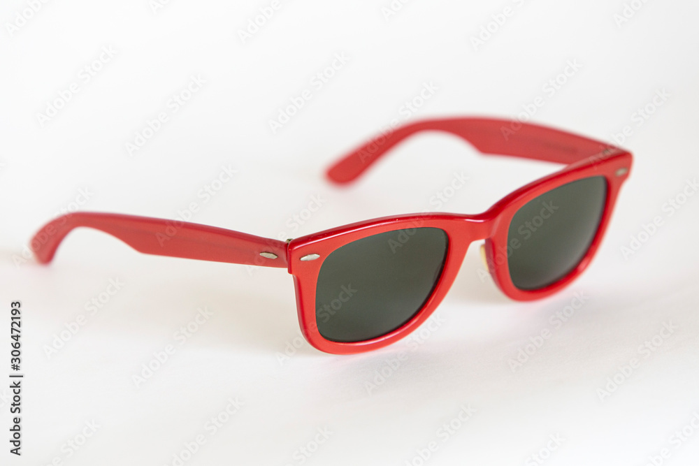 Red classic sunglasses view on white background.Wayfarer sunglasses.