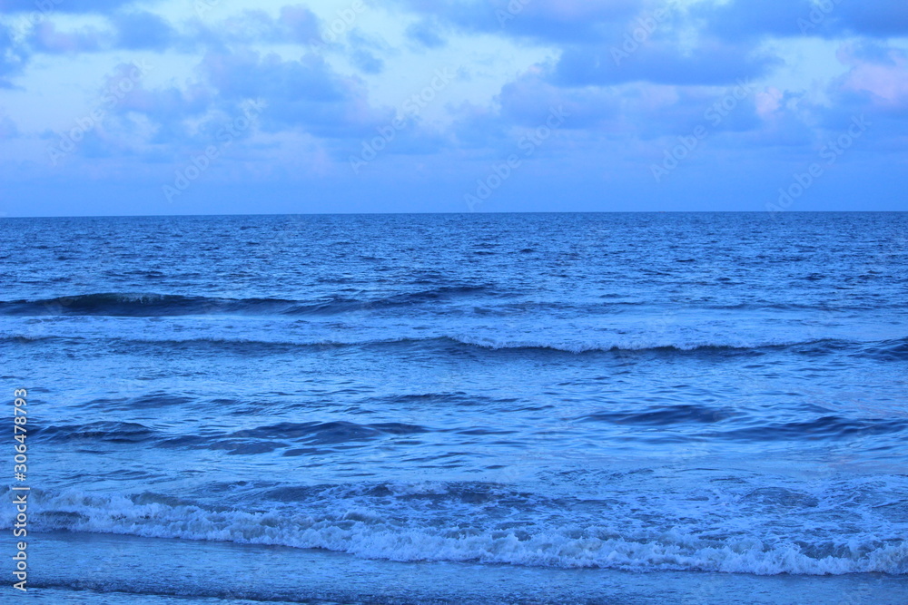 Dark blue color sea or beach water in the evening at chennai marina beach with some waves