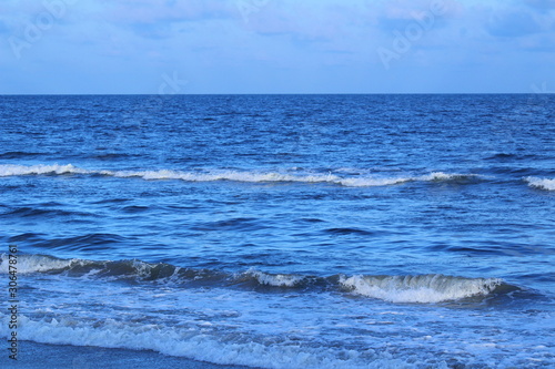 Dark blue color sea or beach water in the evening at chennai marina beach with some waves