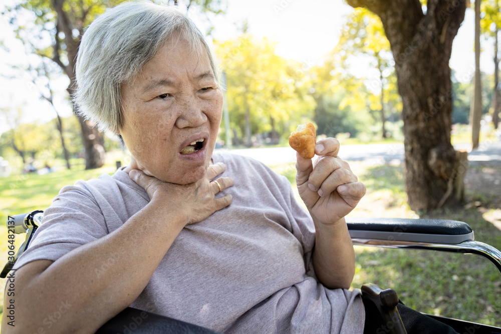 Asian senior woman suffers from choke and cough,clogged up food,elderly
