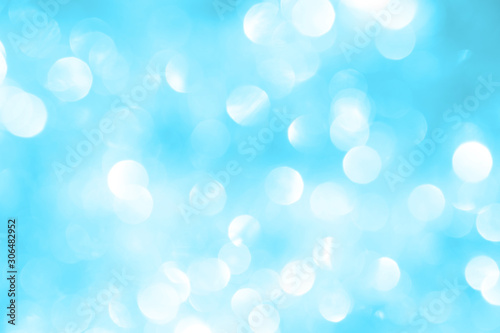 Blue New Year background with blurry spangles for holiday card. 