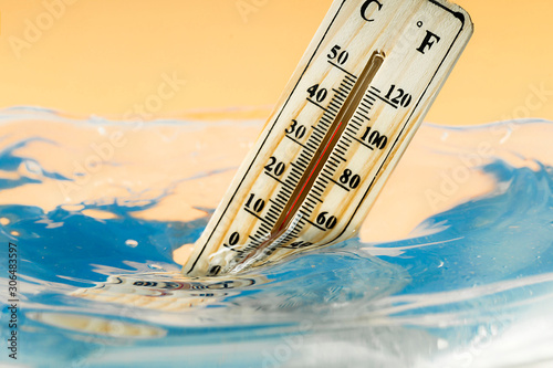 Climate change concept, thermometer immersed in water