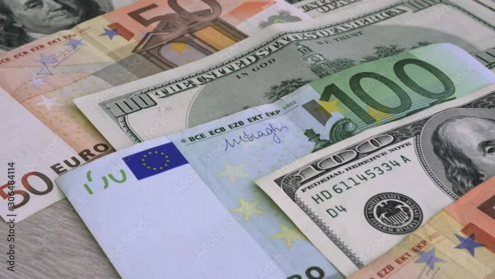 Dollars and euros background. The camera moves along currency.
