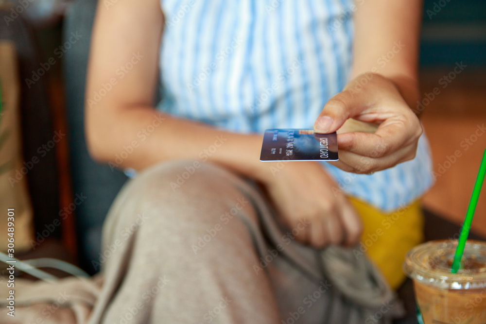 Asian women hold credit cards. Give credit to the camera. Spend via credit card Asian women hold credit cards. Give credit to the camera. Spend via credit card