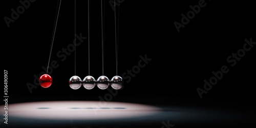 Metallic Balls Mechanism Spotlighted on Black Background photo