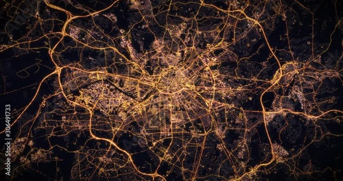 Aerial night view of city of Manchester, UK. Traffic and street light glowing. Camera flying high above, moving closer and rotating from space filming cinematic straight down. 3d animation rendering.
