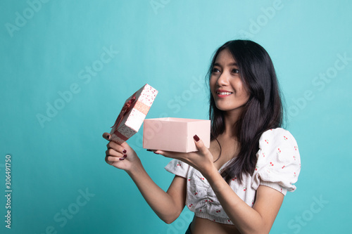 Young Asian woman open a gift box.