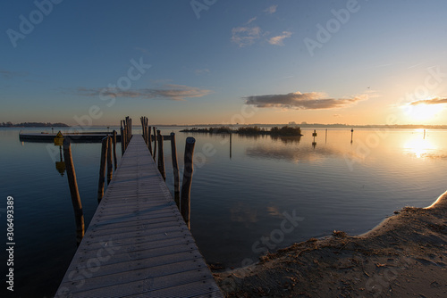 old wooden pier at sunset © robin