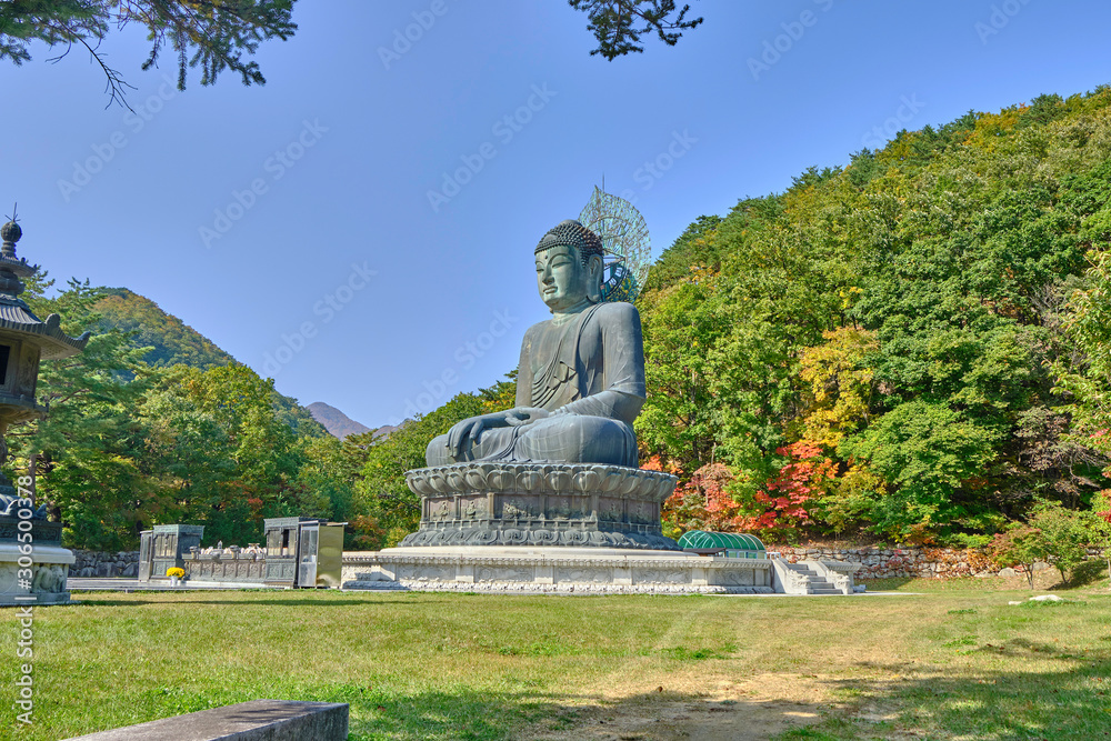 Scenic view of Buddha statue in Sinheungsa buddhistic monastery in mountains of Dinosaur Ridge in Seoraksan national park near Sokcho in South Korea. Beautiful summer sunny look of religious symbol 