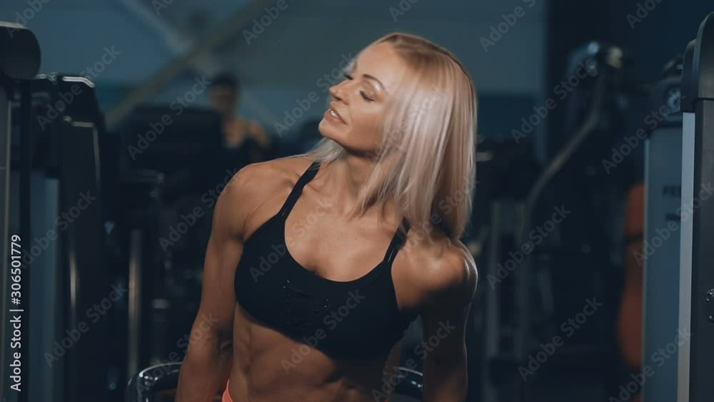 fitness pretty caucasian woman pumping up muscles chest pectorals workout fitness and bodybuilding concept gym background pectorals exercises in gym naked torso fitness pretty caucasian woman pumping up muscles chest pectorals workout fitness and bodybuilding concept gym background pectorals exercises in gym naked torso