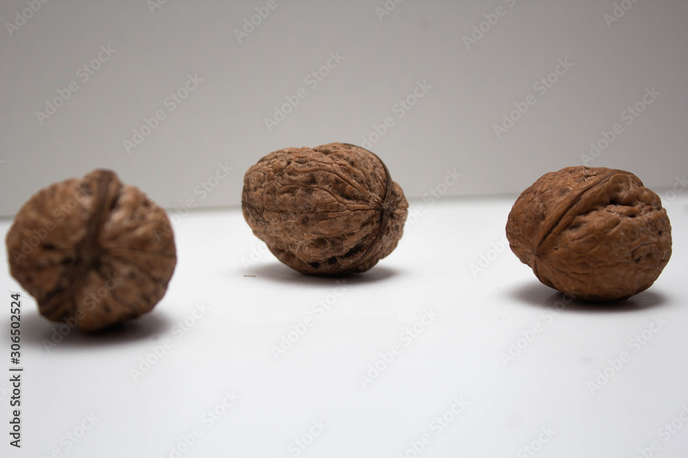 Three Walnuts in a white background, isolate, healthy food Three Walnuts in a white background, isolate, healthy food